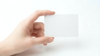 Hand holding blank transparent business card isolated on white background, ready for branding and corporate design mockup.