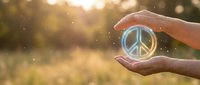 Hands holding glowing peace symbol against blurred nature background with bokeh lights, representing hope, unity and peaceful concepts for wellness and spirituality themes.