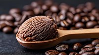 Creamy chocolate ice cream scoop on wooden spoon with scattered roasted coffee beans on dark background, combining dessert and coffee flavors.
