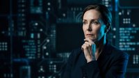 Caucasian male professional in dark business attire contemplating digital data analytics and technology solutions with illuminated cityscape background for corporate concepts.