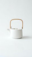 White ceramic teapot with wooden handle isolated on neutral background, suitable for kitchenware, home decor, and tableware design projects.