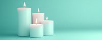 Mint green pillar candles with burning flames arranged in row on turquoise background for spa relaxation meditation aromatherapy wellness home decor.