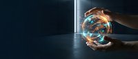Young adult male hand holding glowing digital globe with blue and orange light effects against dark background, representing global connectivity, technology innovation, and worldwide business solutions.