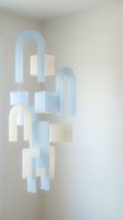 Modern hanging mobile with geometric arches and rectangular shapes in soft blue and cream tones. Minimalist suspended art installation for contemporary interior design and home decor.