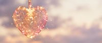 Glowing heart-shaped ornament with warm golden lights against soft bokeh background for romantic holidays and festive celebrations.
