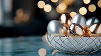 Elegant silver and gold Christmas ornaments in crystal bowl against blurred bokeh lights background, creating festive holiday atmosphere.