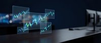 Holographic financial charts and graphs floating above modern desk displaying stock market data analytics for business investment trading technology.