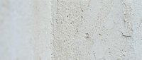 Weathered concrete surface with fine cracks and dust particles, suitable for backgrounds, textures, industrial design, construction materials, and architectural projects.