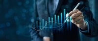Professional businessman in suit drawing upward trending growth chart with glowing blue data visualization elements representing financial success and analytics.