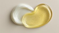 Luxurious gold and white cosmetic cream samples on beige background, showcasing rich texture and glossy finish for skincare product advertising.