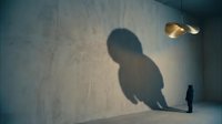 Silhouette of large shadowy figure looming over small person standing alone in minimalist concrete room with golden pendant light, conveying isolation, fear, and psychological tension for conceptual storytelling.