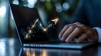 Glowing financial graph with upward arrow trend on laptop screen while businessman works in dark office, showing digital market growth analysis.