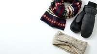 Winter accessories collection with knitted scarf, mittens and headband in traditional patterns isolated on white background for seasonal fashion design.