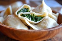 Fresh steamed dumplings filled with vibrant green spinach served in rustic wooden bowl, close-up view showing delicate pleated edges and tender wrapper texture.