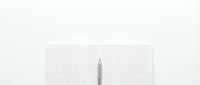 Minimalist pencil on grid paper background for creative writing, sketching and design projects. Clean workspace concept with copy space.