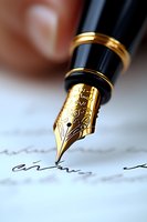 Gold fountain pen nib with ornate engravings writing signature on white paper, macro photography showing fine details and craftsmanship in luxury writing instrument.