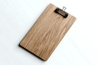 Wooden clipboard with metal clip isolated on white background, minimalist office stationery for business presentations and document organization.