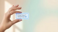 Hand holding glowing contract verified badge with blue checkmark, symbolizing digital agreement approval, authentication, and legal validation.