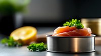 Fresh raw salmon fillet in metal tin can with herbs and lemon on dark background, selective focus. Healthy seafood protein source for cooking.