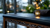 Glowing decorative candle holder on dark table with bokeh lights in background creates cozy evening atmosphere at home or restaurant setting.