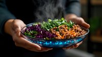 Steaming hot rice bowl with minced meat, shredded purple cabbage and fresh herbs served in blue ceramic dish, hands holding healthy meal.