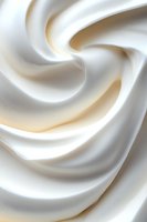 Smooth swirling cream texture with soft waves and curves creating an elegant abstract pattern in white and beige tones, macro photography for food industry background.