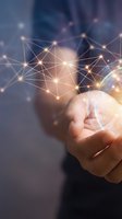 Hand holding glowing digital network with interconnected nodes and light particles, representing data connection, technology innovation, and global communication for business solutions.