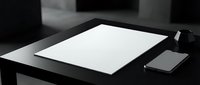 Minimalist black and white workspace with blank paper sheet and smartphone on dark desk. Clean office setup for business presentations and corporate branding.