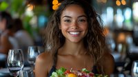 Young mixed race woman with bright smile holding fresh healthy salad plate at restaurant, casual dining atmosphere with soft bokeh background lighting.