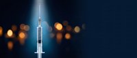 Medical syringe with needle on dark blue background with warm bokeh lights for healthcare and vaccination concepts.