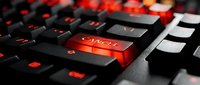 Red delete key on black computer keyboard with dramatic lighting for technology and data management concepts.