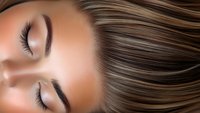 Close up view of young woman with closed eyes, long brown hair and natural makeup showing flawless skin texture and professional beauty treatment results.