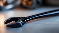 Black adjustable wrench on blurred background with dramatic lighting and shallow depth of field, industrial tool macro photography for maintenance concepts.