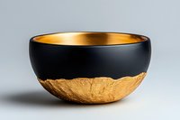 Elegant black and gold ceramic bowl with rough textured bottom half and smooth matte finish top, featuring contrasting interior golden glaze on neutral background.