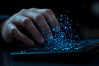 Female hand typing on keyboard with magical blue glowing particles rising from keys in dark atmosphere, representing digital transformation and technology innovation.