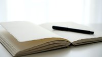 Open notebook with blank pages and black marker on white surface, ready for writing, planning, or creative work.