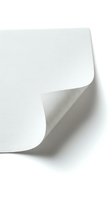 White paper sheet with curled corner edge isolated on white background for design projects and presentations.