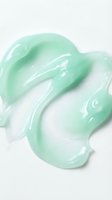 Mint green gel or serum texture with glossy, translucent swatches on white background, suitable for cosmetics, skincare, and beauty product packaging design.