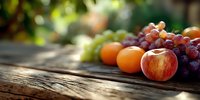 Fresh seasonal fruits arranged on rustic wooden table with soft natural lighting, creating warm atmosphere for food photography and healthy lifestyle content.