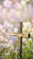 Weathered wooden cross surrounded by delicate wildflowers with soft bokeh background for memorial, spiritual and peaceful garden concepts.