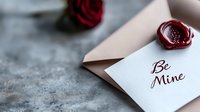 Romantic love letter with red wax seal and rose on textured surface for Valentine's Day greeting cards and wedding invitations.