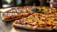 Fresh baked pizza with melted cheese and tomato sauce on rustic wooden table, selective focus on crispy crust with basil garnish, macro food photography.
