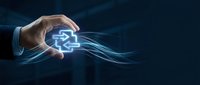 Businessman hand holding glowing digital gear symbol with flowing light streams on dark background, representing technology innovation and business solutions.