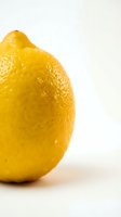 Fresh yellow lemon with textured peel isolated on white background for culinary and health concepts.
