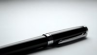 Elegant black fountain pen with silver accents on white background, professional writing instrument for business documents and signatures.