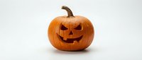 Carved Halloween pumpkin jack-o-lantern with spooky face isolated on white background for autumn holiday decorations and seasonal design projects.