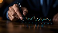 Male hand analyzing financial market data on digital screen with candlestick chart pattern, dark moody lighting creates dramatic business atmosphere.
