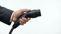 Professional businessman hand holding black hair dryer on white background isolated for grooming and personal care design projects.