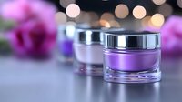Luxury purple cosmetic cream jar with silver cap on elegant surface with pink flowers and bokeh lights background for skincare and beauty products.