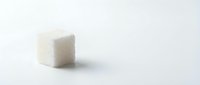 Isolated white sugar cube on neutral background, ready for culinary, food photography, and design projects.